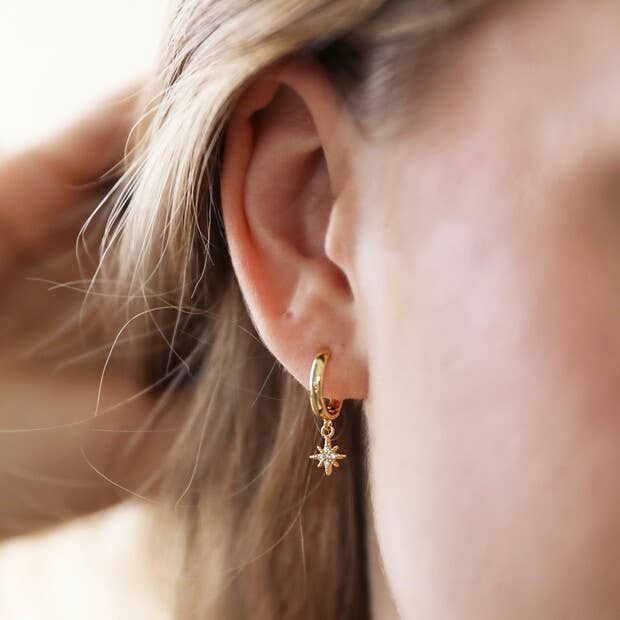 Sunburst and Star Charm Huggie Hoop Earrings in Gold