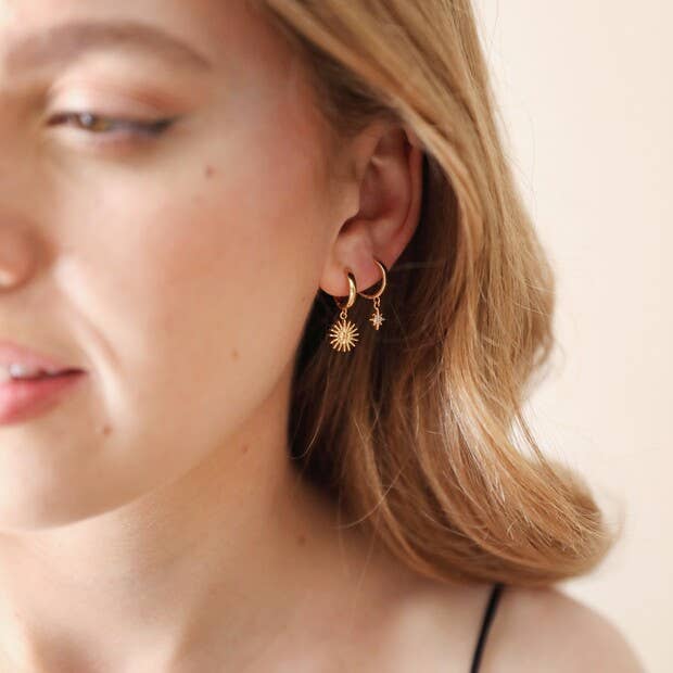Sunburst and Star Charm Huggie Hoop Earrings in Gold